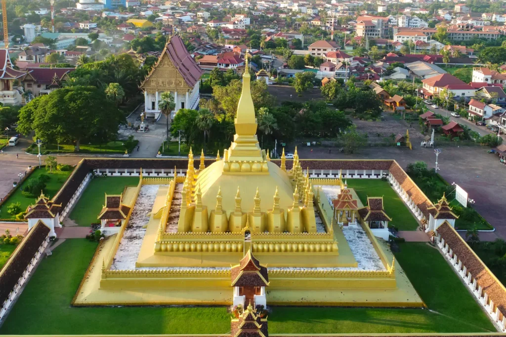Aerial view of golden stupa and cityscape in Vientiane, Laos.