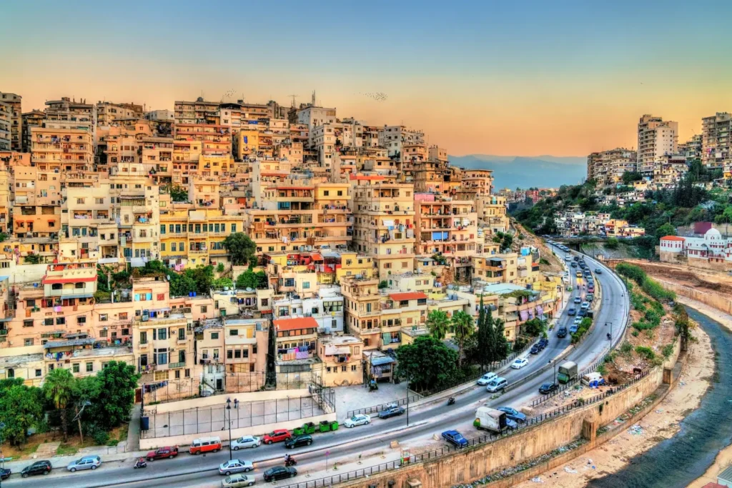 Cityscape of Beirut, Lebanon with buildings along the hillside at sunset.