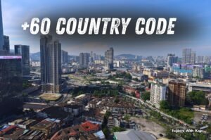 Aerial view of Kuala Lumpur city skyline with text overlay “+60 Country Code,” representing Malaysia’s international dialing code.