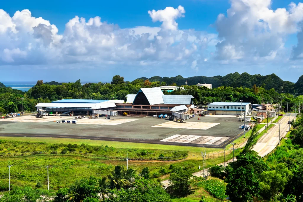 A small island airport surrounded by lush greenery in Micronesia.