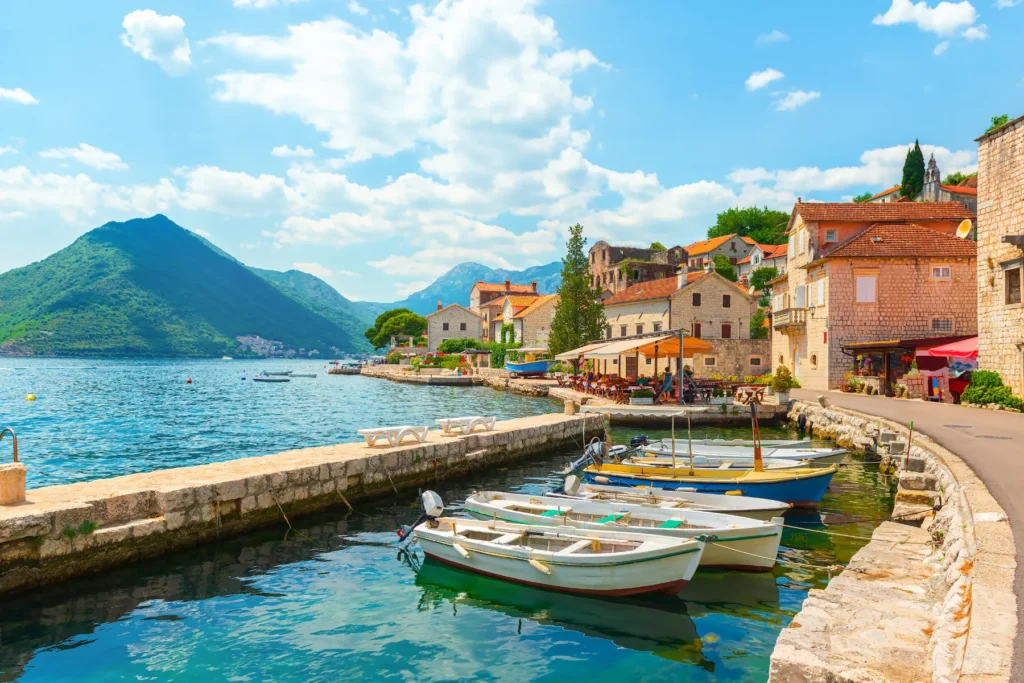Boats and stone houses along the Bay of Kotor in Montenegro.