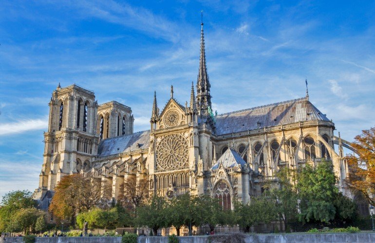 Notre-Dame Cathedral in Paris with Gothic towers and river view.