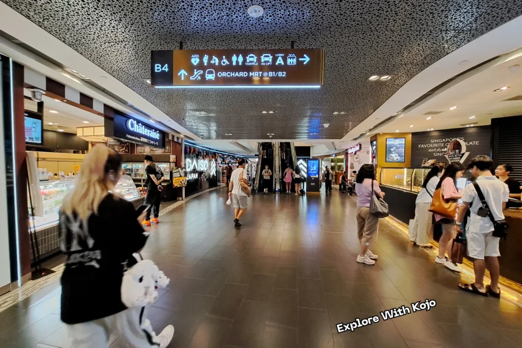 Signage at ION Orchard showing directions to Orchard MRT and facilities in Singapore