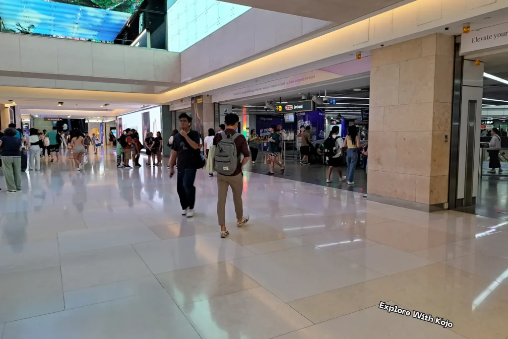 People walking inside ION Orchard Mall near Orchard MRT station entrance in Singapore