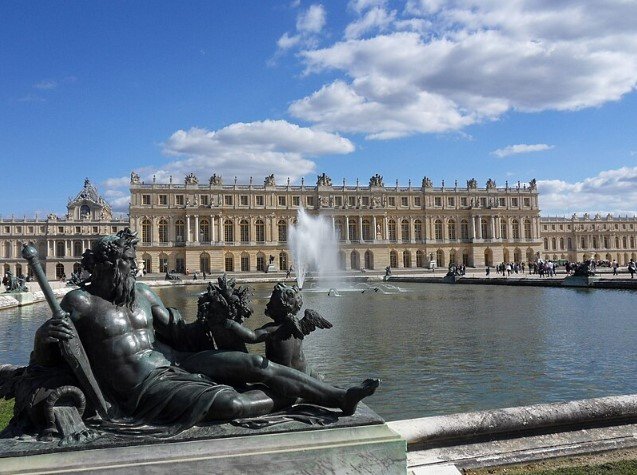 The grand Palace of Versailles in France with gardens and fountains.