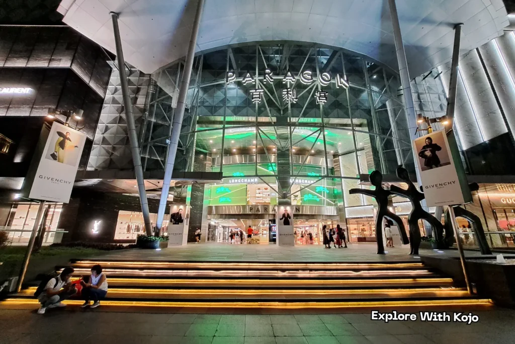 Entrance of Paragon Mall on Orchard Road Singapore lit up at night with Givenchy and Longchamp stores