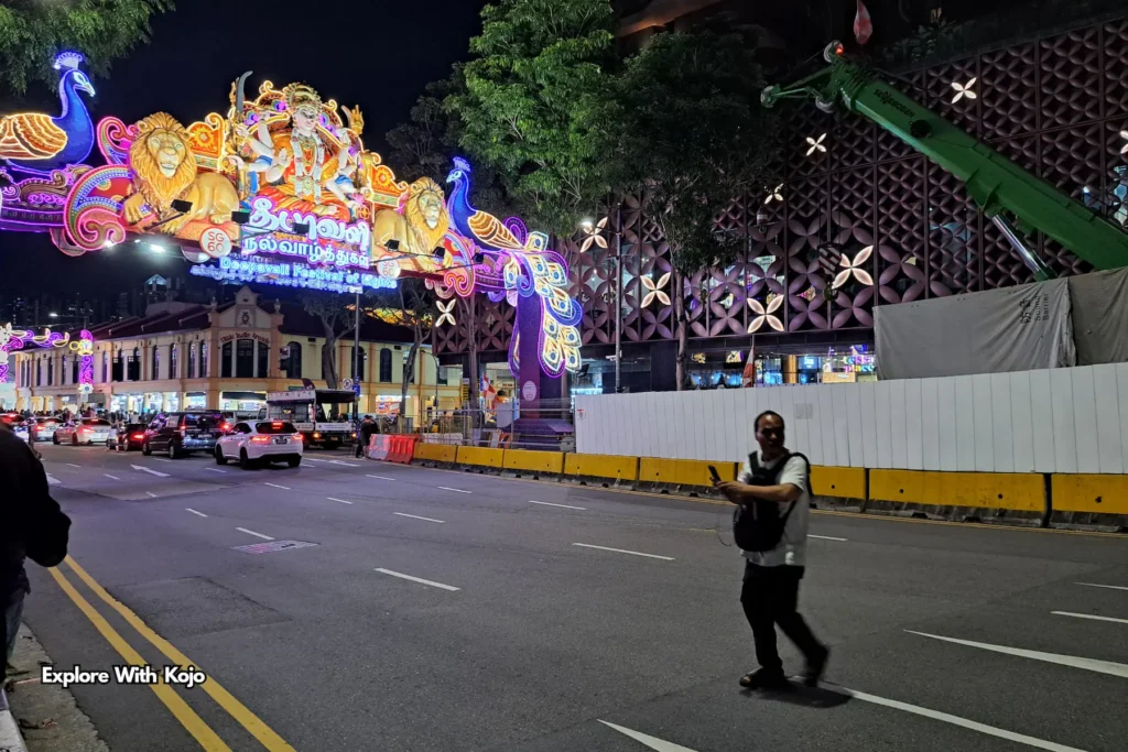 Man crossing the road near Deepavali arch on Serangoon Road Singapore
