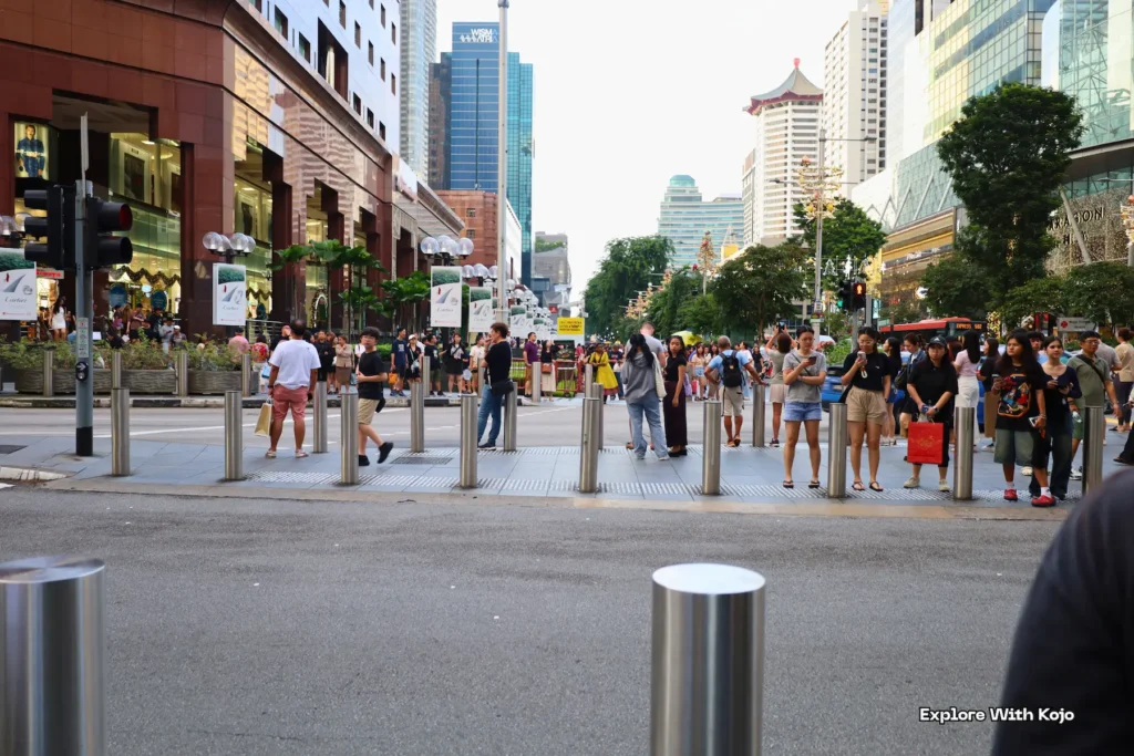 Pedestrians waiting to cross Orchard Road in Singapore