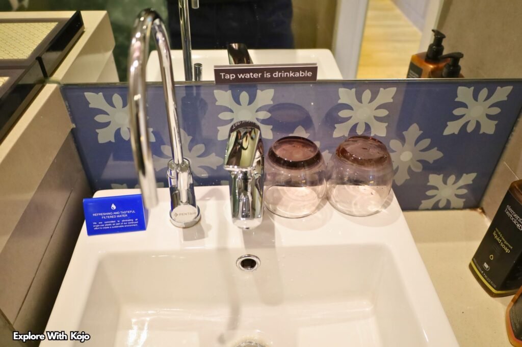 Sink with a sign saying “Tap water is drinkable” in Singapore
