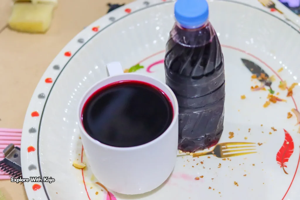 Cup and bottle of Ghanaian sobolo drink made from hibiscus leaves