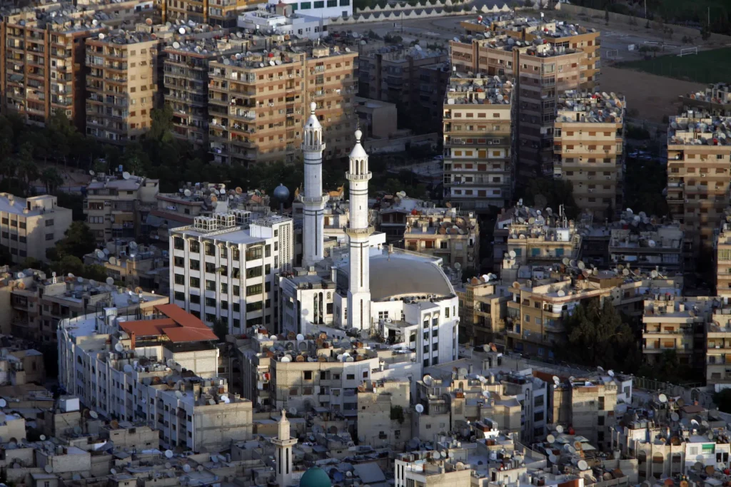 Aerial view of Aleppo city with a mosque surrounded by dense buildings in Syria.