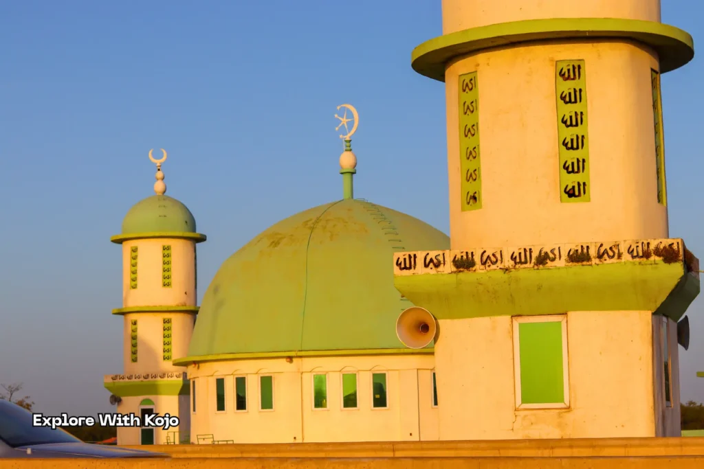 Tamale Central Mosque with green domes and minaret under clear blue sky