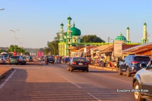 Street view of Tamale with the green-domed central mosque in the background