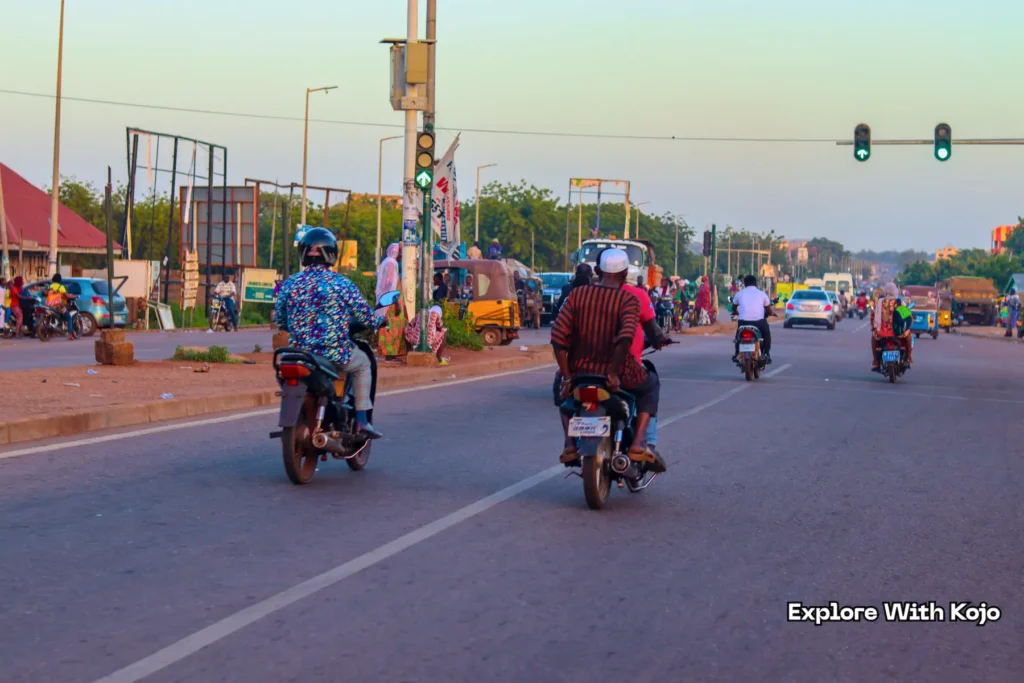 Green-domed Tamale Central Mosque with cars and motorbikes on the road