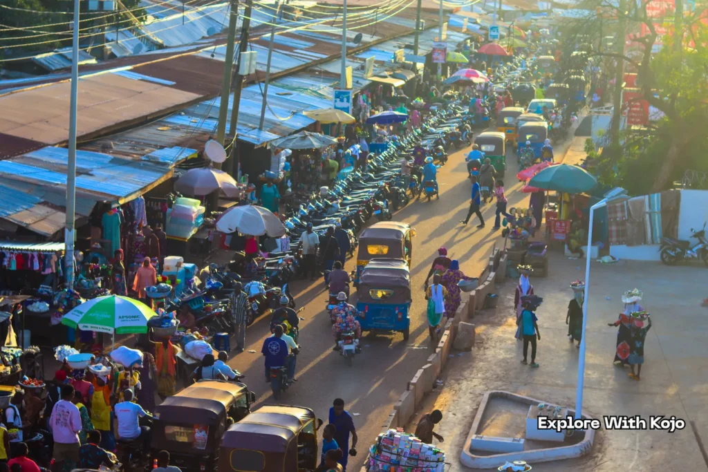 Street view of Tamale main market with traders and Yellow Yellow taxis