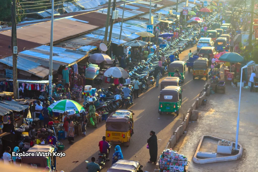 Busy Tamale market with people and vehicles