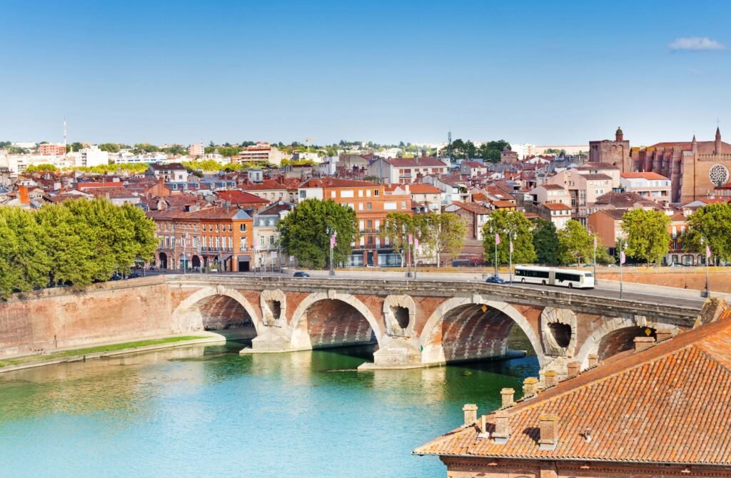 Bridge over the Garonne River in Toulouse with cityscape in the background