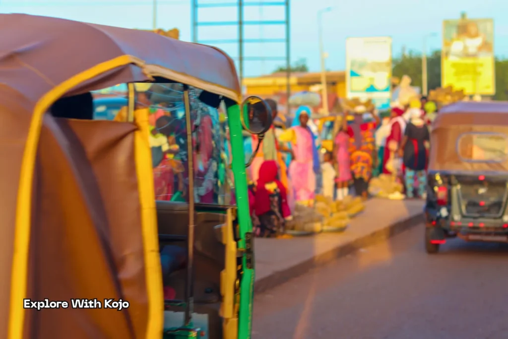 Traders standing between motorbikes and stalls in Tamale market