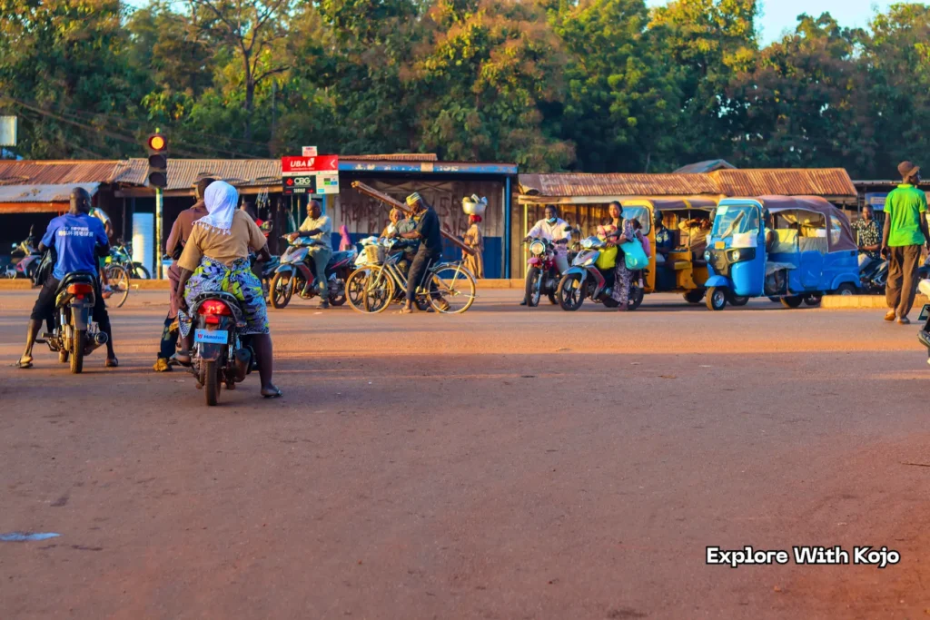 Motorbikes and tricycles moving through busy traffic in Tamale Ghana
