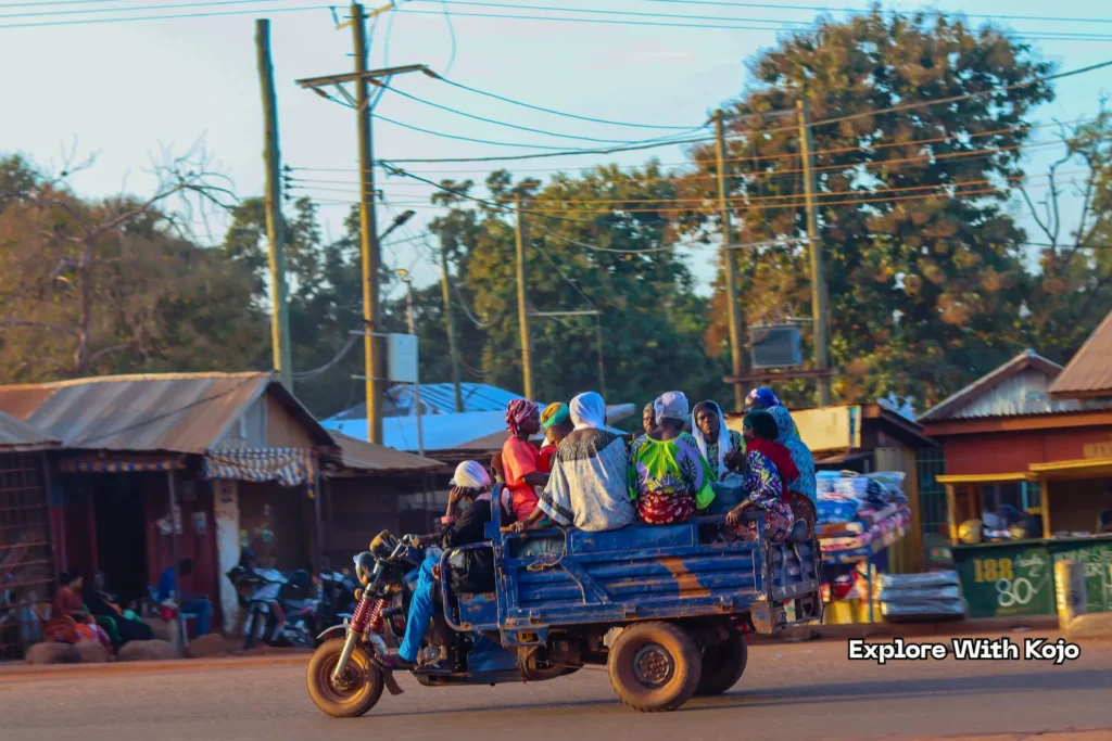 Village women riding in a Motorking tricycle after market day