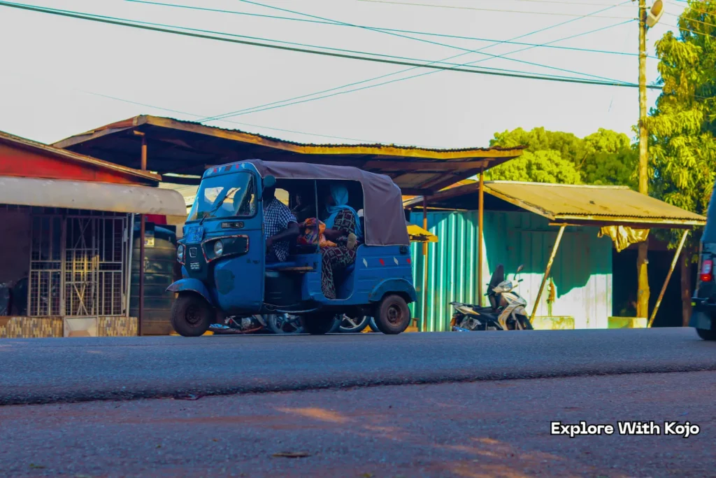 Blue tricycle taxi known as Yellow Yellow carrying passengers in Tamale, Ghana