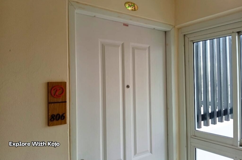 A white hotel room door in Bangkok, used to illustrate the importance of checking your room and asking for a room change if something feels off.