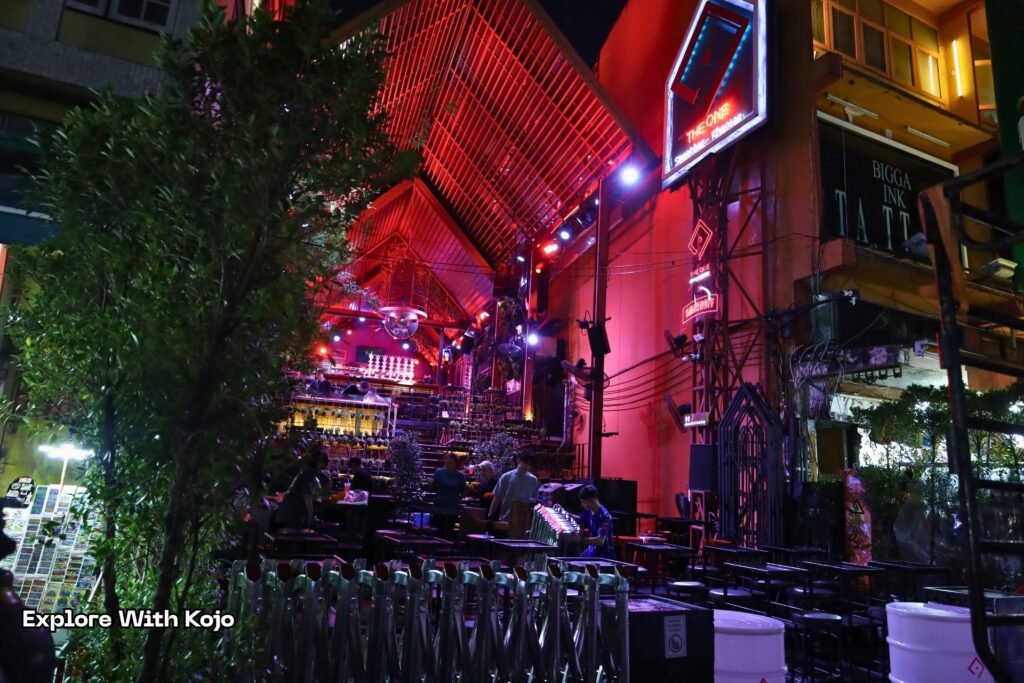 Nightlife street in Bangkok where many tourists get lured by happy hour girls offering cheap drinks that lead to expensive surprises.