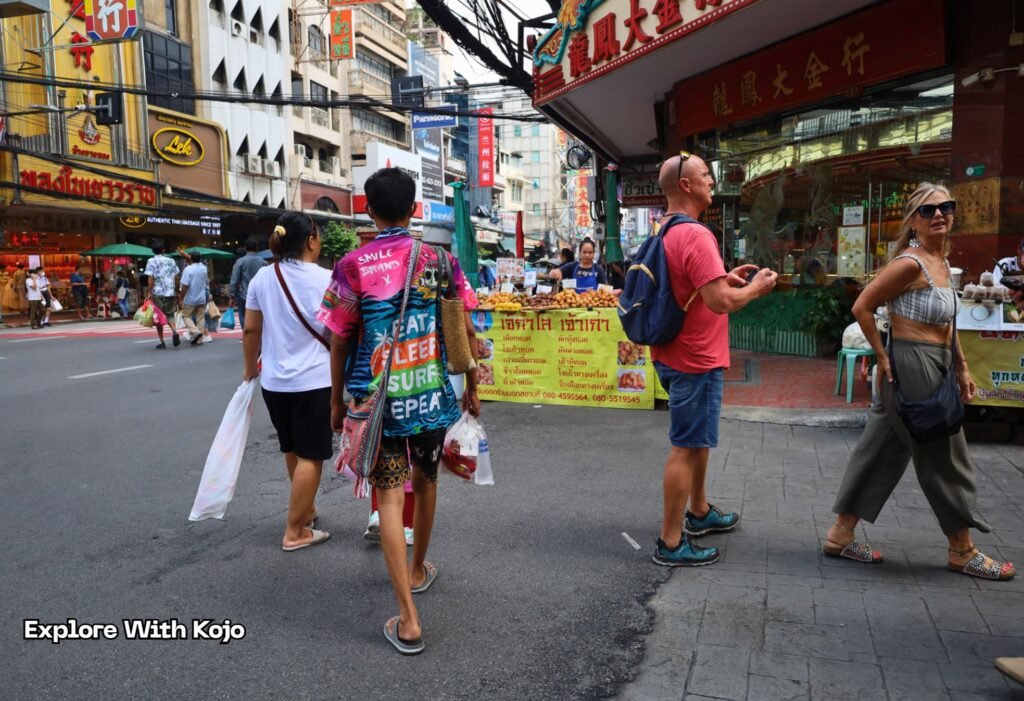 Tourists walking through a busy street in Bangkok Chinatown, representing how Thailand’s updated 2025 visa rules affect normal visitors.