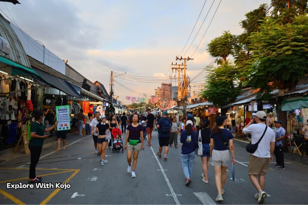 Crowds walking through Chatuchak Weekend Market during the late afternoon.