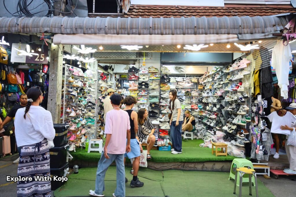 Shoppers exploring narrow lanes at Chatuchak Weekend Market.