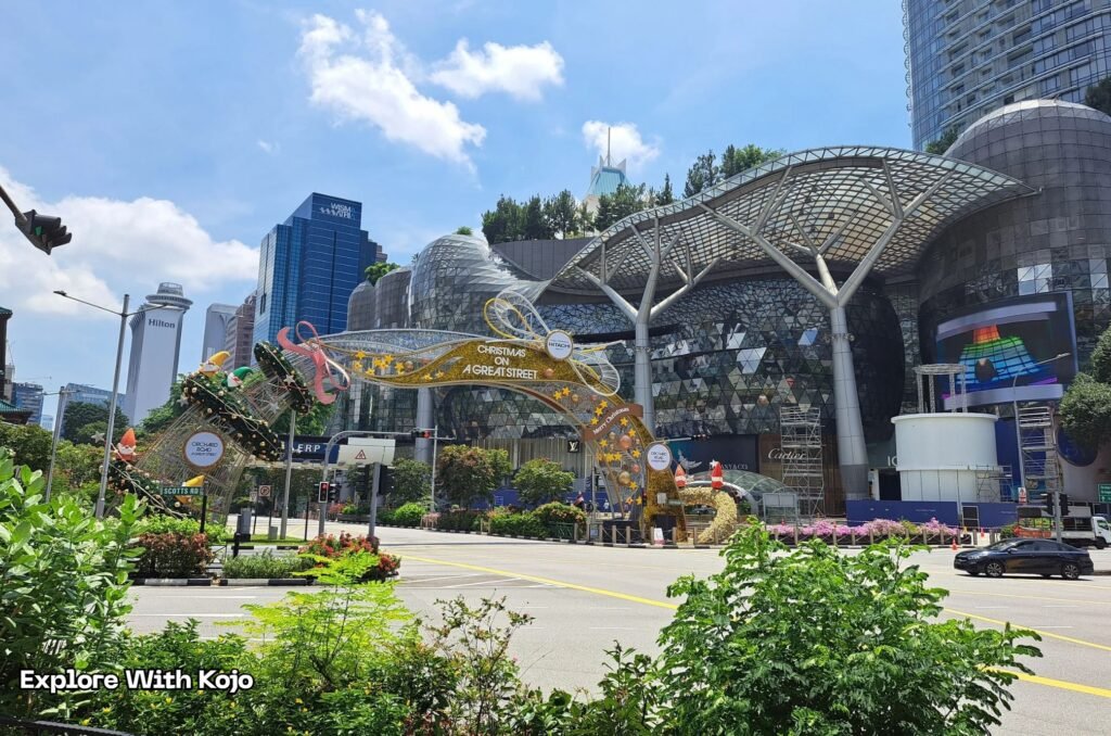Daytime view of ION Orchard with the Christmas on A Great Street arch and Hilton Singapore in the background.