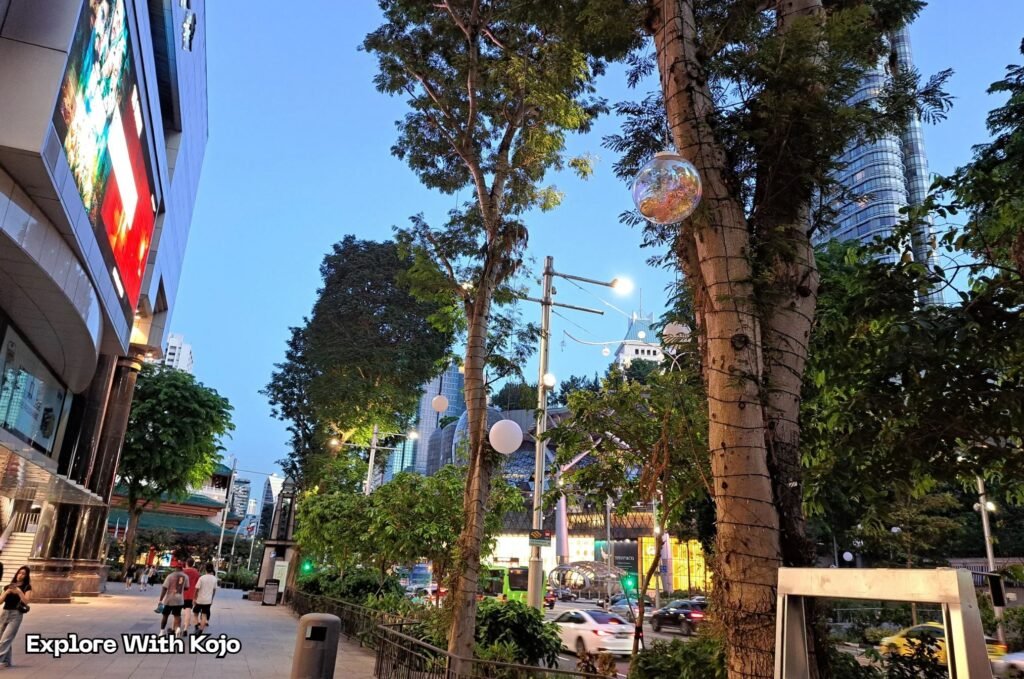 Close-up of decorated trees along Orchard Road with festive bulbs.