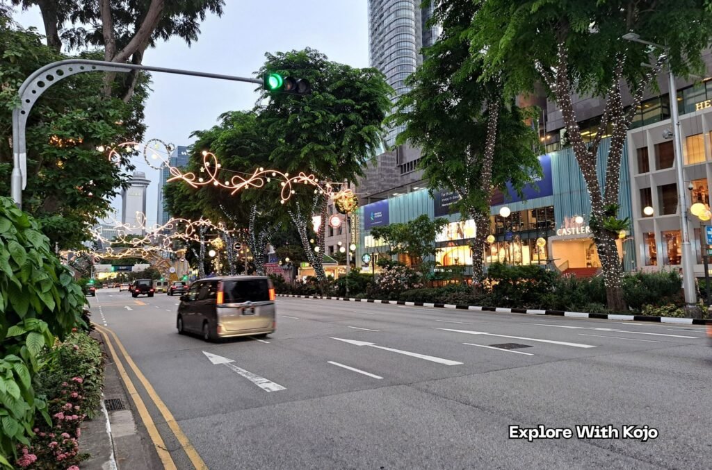 Early evening view of Orchard Road with Christmas decorations and traffic as Singapore prepares for the 2025 holiday season.