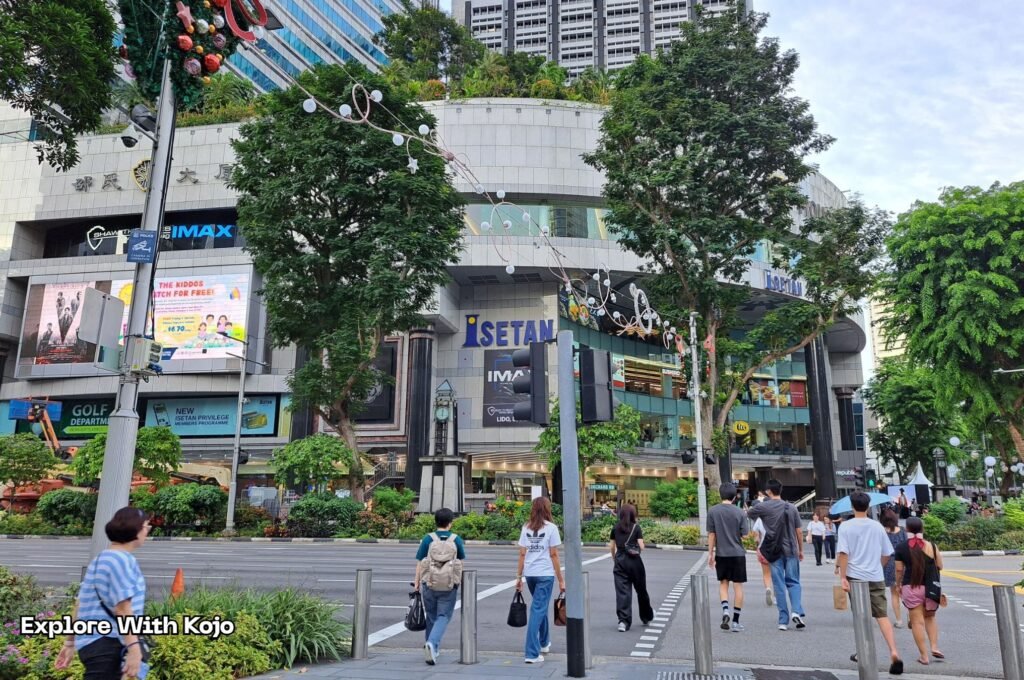 Orchard Road Isetan and IMAX crossing with early Christmas decorations.