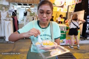 Sabrina eating mango sticky rice at a Thai street food stall