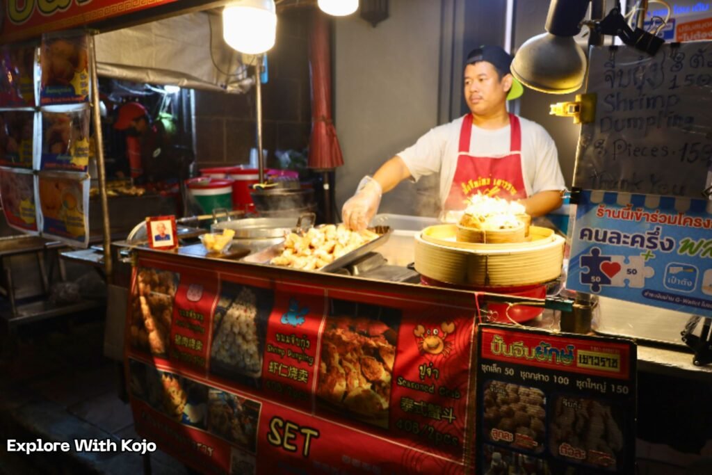 A Thai street food vendor cooking shrimp dumplings at Yaowaraj in Chinatown Bangkok, Thailand.
