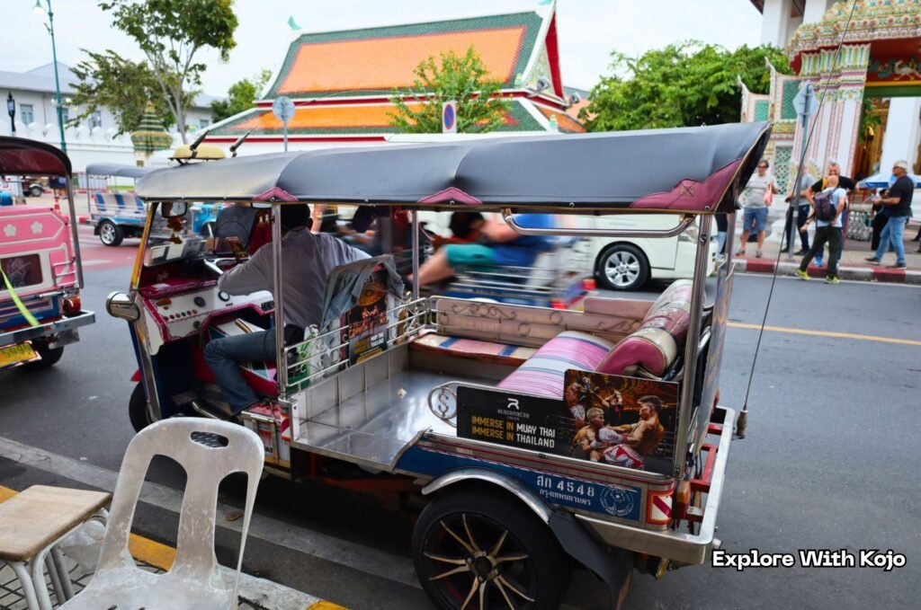 A Bangkok tuk tuk parked near a temple area, used in my guide explaining how tuk tuk scams happen in Thailand.