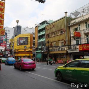 Cars and tuk-tuks moving through Chinatown in Bangkok.