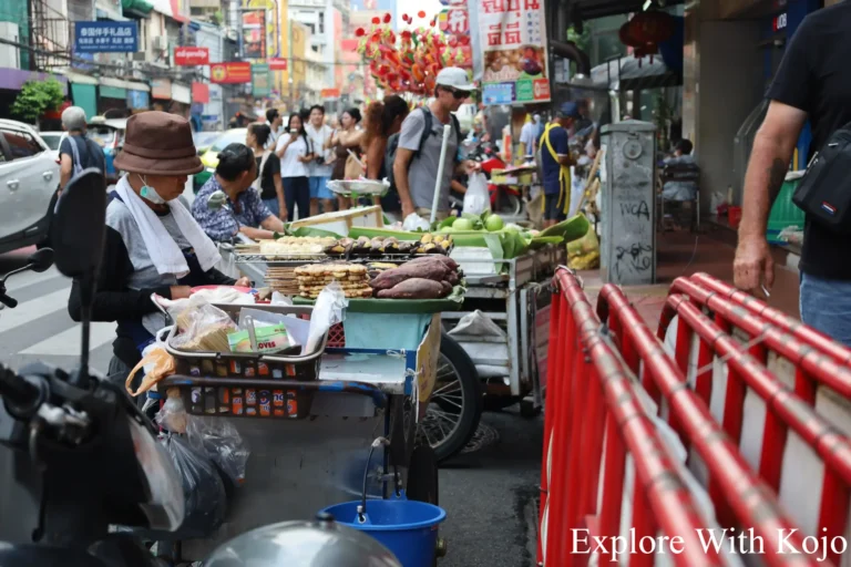 Vendors selling local Thai dishes on a Bangkok street.