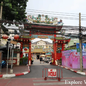 Ornate temple gate with dragons and lanterns in Bangkok&rsquo;s Chinatown.