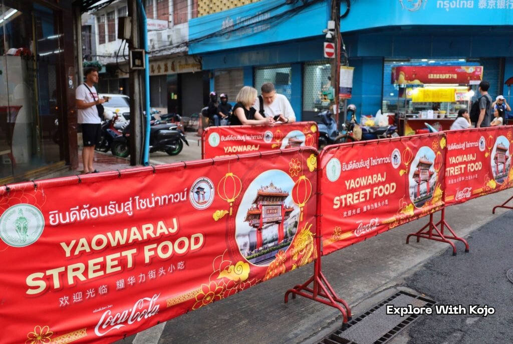 Tourists exploring Yaowaraj Street Food market in Chinatown Bangkok, Thailand.