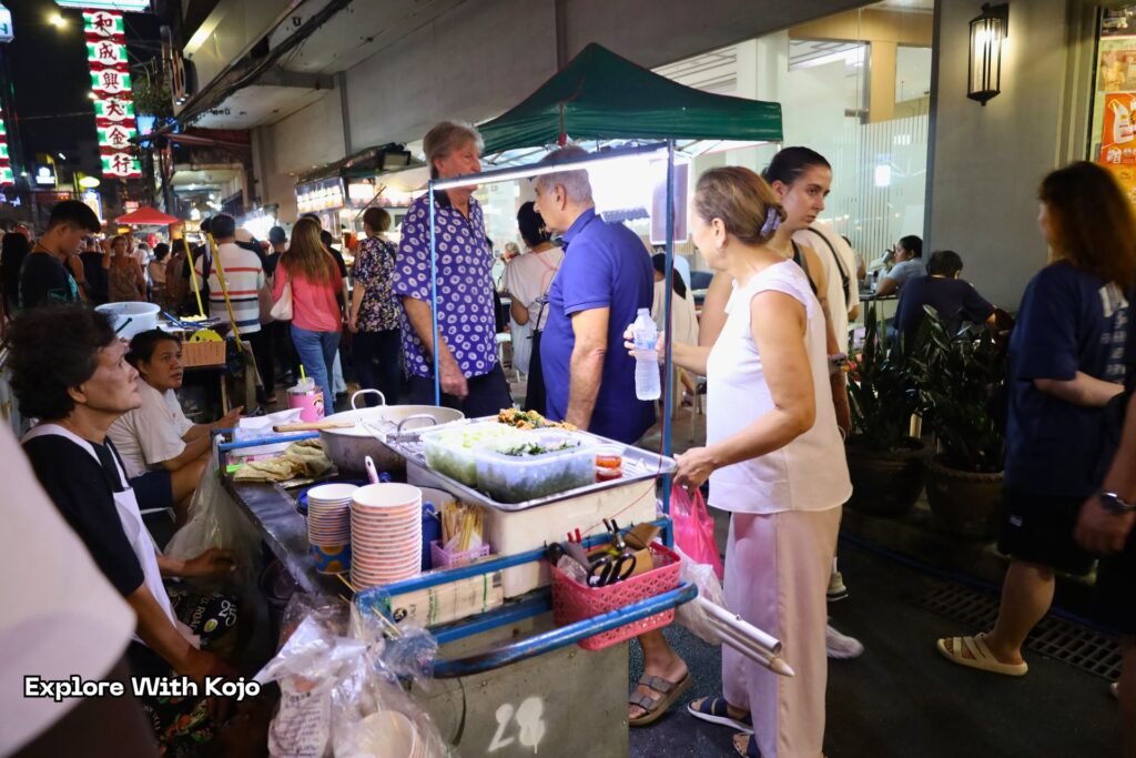 Small makeshift street food stall in Bangkok Chinatown serving fresh meals.
