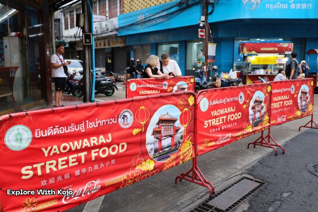Street food signs on Yaowarat Road marking the start of Chinatown’s night food market.