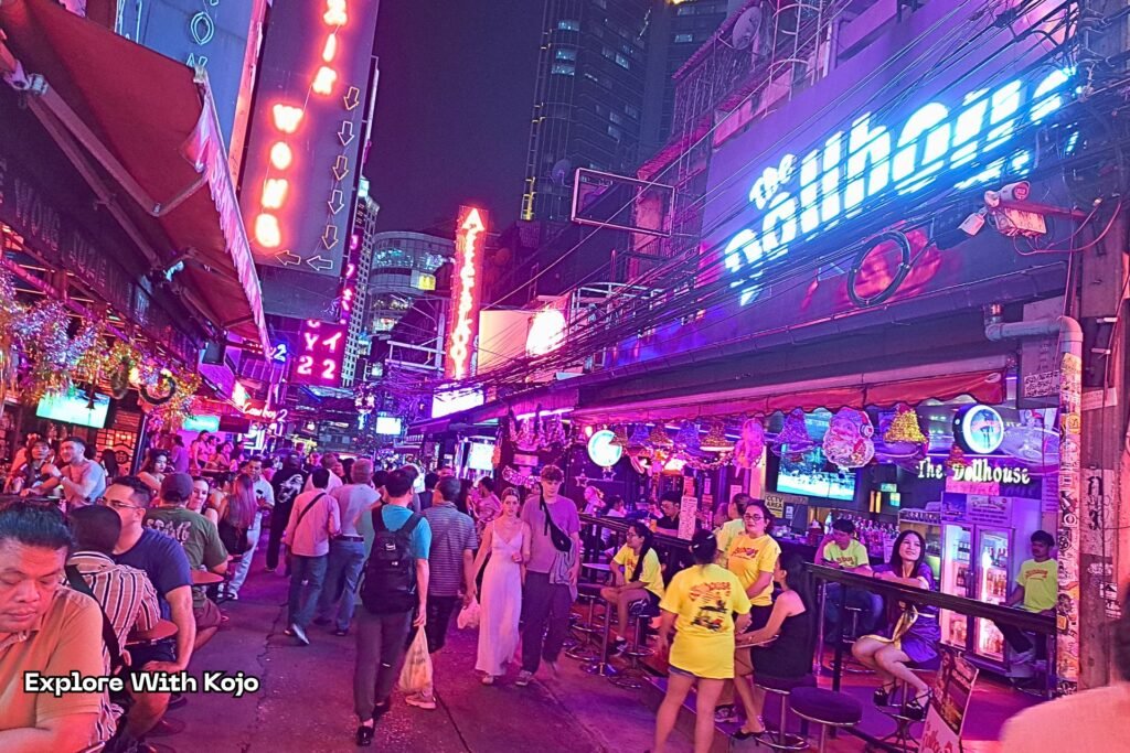 Nightlife street in Bangkok with lights and people at night