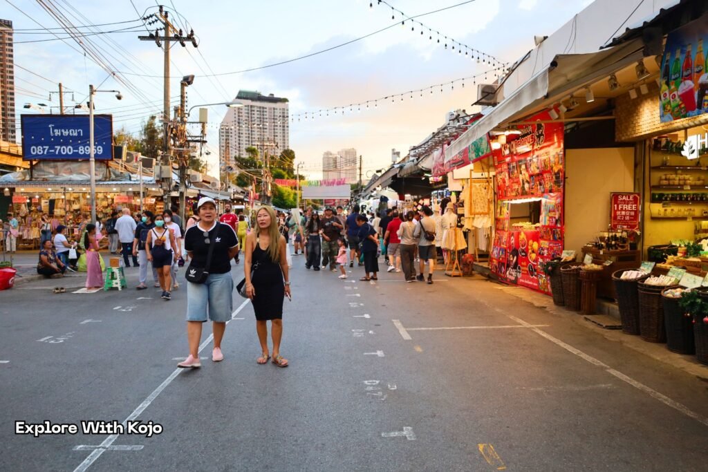 Thai girls shopping and walking through a busy street in Bangkok